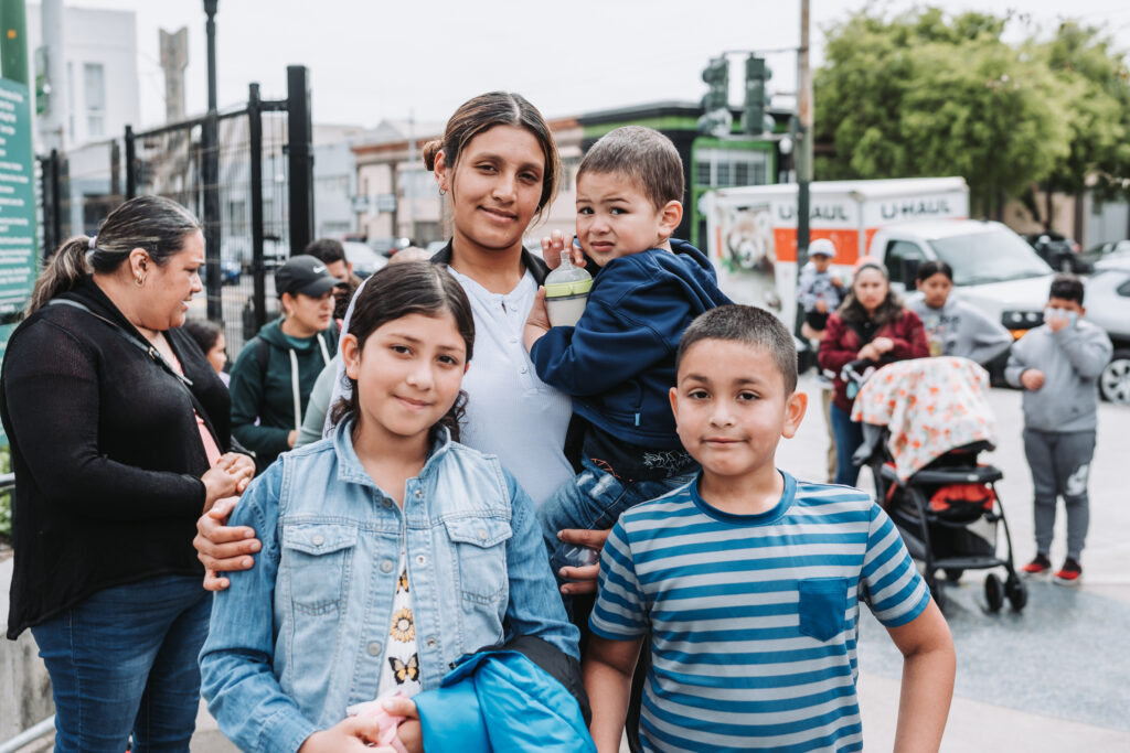 mother with three children outside at event
