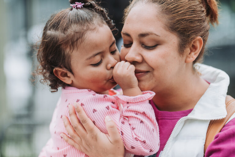 mother holding young toddler