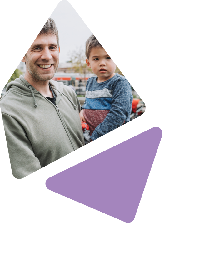 father holding toddler child outside