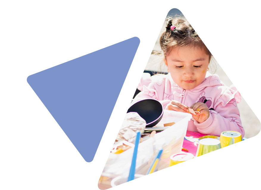 Young girl playing with art supplies outside