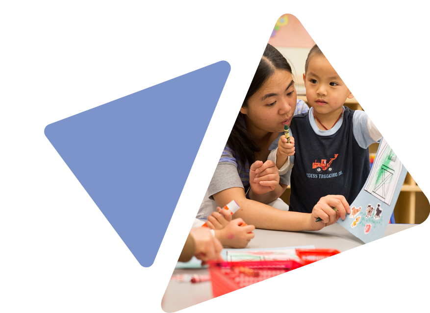 Young child at classroom table with teacher