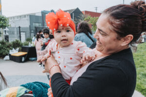 Parent holding infant child outside