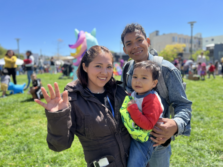 mom and dad with infant child outside